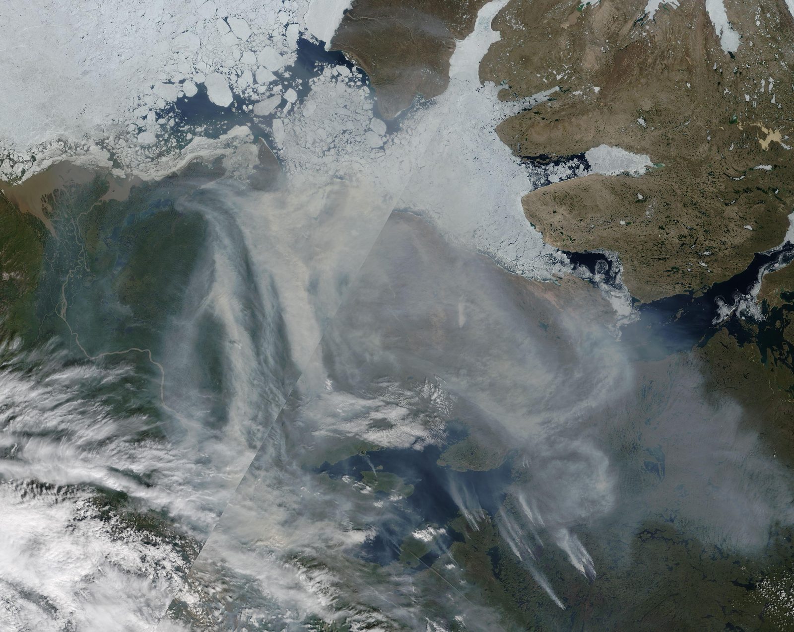 MODIS satellite view of Canada's Northwest Territories with many red fire detections and thick smoke over the land around Great Bear Lake