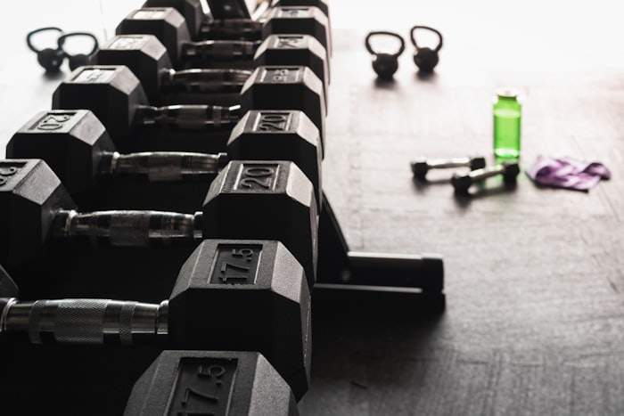 Person mid strength-training set in a gym
